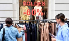 Women browse clothes sales in Rennes, France.