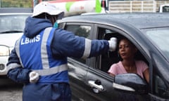 A health official measures the temperatures of motorists as a preventive measure against the spread of Covid in Maseru, Lesotho, in March 2020.