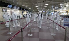 South Korean soldiers wearing protective gear spray disinfectant to help prevent the spread of the coronavirus at the Daegu international airport.