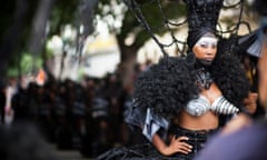 A performer from Los Carpinteros (a Cuban artist duo) at the Havana Biennial, taking part in a traditional Cuban carnival street procession, performed in reverse