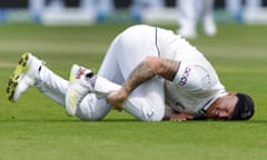 Ben Stokes clutches his shin after being hit by the ball on the first day at Old Trafford