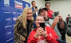 Marjorie Taylor Greene poses for a selfie with Trump supporters.