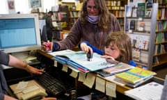 Aberystwyth Carnegie funded public lending library, Wales UK<br>CPD012 A girl stamping her own book at the old Aberystwyth Carnegie funded public lending library, Wales UK