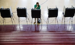A voter casts a ballot in Georgia’s primary election at a polling site in a high school gymnasium Tuesday, March 1, 2016, in Atlanta. (AP Photo/David Goldman)