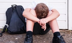 A boy of 10 looking sad and depressed in his school uniform showing the effects of bullying in the Uk<br>DG715A A boy of 10 looking sad and depressed in his school uniform showing the effects of bullying in the Uk