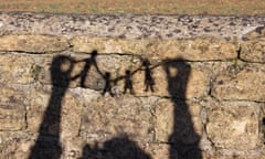 Family paper chain silhouettes against wall