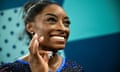 Simone Biles poses with her goat necklace after her victory
