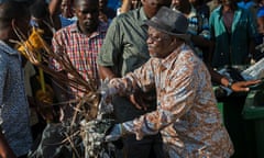 Tanzanian president John Magufuli joins a clean-up event in Dar es Salaam on 9 December 2015.