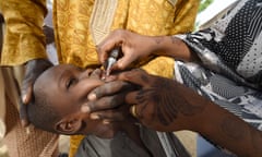 A health worker administers a polio vaccine to a child in north-west Nigeria