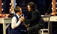 Hanna Hipp kneels before Jennifer France who sits at a backstage dressing-room table with lights all round the mirror