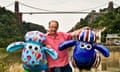 Animator Nick Park with giant sculptures of Shaun the sheep in front of the Clifton suspension bridge in Bristol.