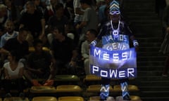 An Argentina and Lionel Messi fan holds a national flag