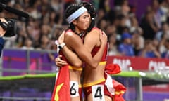 Lin Yuwei (left) hugs Wu Yanni after the Women's 100m hurdles final  at the Asian Games in Hangzhou, eastern China