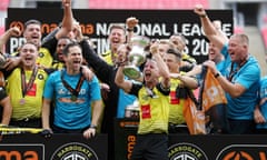 Josh Falkingham of Harrogate Town lifts the trophy after his team’s comfortable victory in the National League play-off final against Notts County.