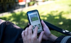 Person playing Wordle in garden