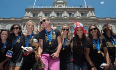 Flanked by her teammates, Abby Wambach holds their trophy at New York’s city hall as the US Women’s World Cup soccer champions celebrate following a ticker-tape parade.