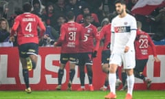 Jonathan David celebrates his goal with teammates as Marco Asensio looks dejected during the Ligue 1 match between Lille and Paris Saint-Germain