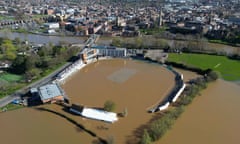 Aerial view of a cricket ground flooded with brown water