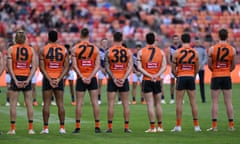 The Giants and the Dockers, wearing black armbands, stand for a moment’s silence in memory of the Hunter Valley bus crash victims during the AFL Round 14 match on Saturday.