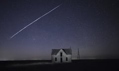 In this photo made with a long exposure, a string of SpaceX StarLink satellites passes over an old stone house near Florence, Kan., on Thursday, May 6, 2021. (AP Photo/Reed Hoffmann, File)