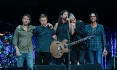 The Foo Fighters looking grave on stage at Wembley Stadium