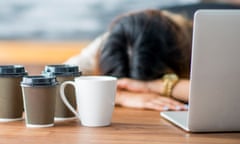 Tired Entrepreneur<br>A female entrepreneur and businesswoman is working on her start up company in her office. She has fallen asleep at the office with her head on her desk. Empty coffee cups are on the table.