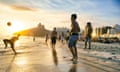 Young Brazilian men play keepy uppy on the beach