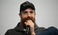 Mike Cannon-Brookes smiling and holding a microphone