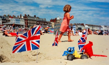 A girl plays on the beach at Weymouth in 1998, as shot by Martin Parr.
