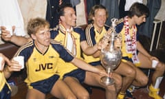 The cup floweth over … Kevin Richardson, Steve Bould, Paul Merson and Alan Smith celebrate with the First Division trophy after Arsenal beat Liverpool 2-0 in May 1989 after late drama.
