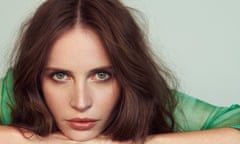 Facial close-up of Felicity Jones , leaning on her hands, in a green top
