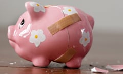 Close-up of a broken piggy bank with sticky plasters