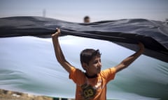 A Palestinian boy waves the national flag during demonstrations in the West Bank.