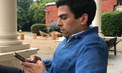 Ammar Kalia scrolling on his phone.