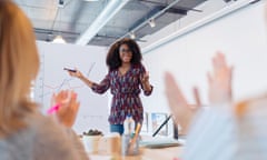 Woman leading meeting at flipchart in conference room