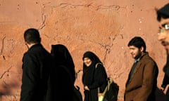 Iranians make their way at the sidewalk of  Enghelab-e-Islami (Islamic Revolution) Street in Tehran.