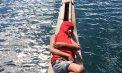 Drifting off – a man in a red hoodie asleep on his boat.
Tufi is on mainland Papua New Guinea and is an area of tropical fjords and rich fishing grounds for the indigenous people. These fishermen still mostly use dugout outrigger canoes in order to get around since the area has no roads.