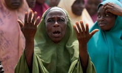 A woman holding both hands up with the palms towards her.