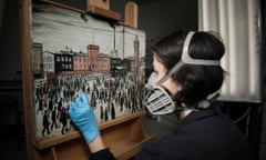 Painting Conervator, Nicoletta Tomassi cleaning Lowry's "Going to work" (1943), (Factory workers going to work at the Mather &amp; Platt, Manchester, in the snow.) in the conservation lab (E20) at IWM London. Photographed 14th May 2019