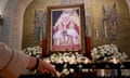 A woman lights a candle for the late Pope Benedict XVI at Manila Cathedral in the Philippines.