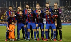 TOPSHOT - Afghan boy Murtaza Ahmadi poses for a picture with the FC Barcelona team: (top L to R) Rafinha, Javier Mascherano, André Gomes, Ivan Rakitic, Gerard Piqué, Ter Stegen (bottom L to R) Lionel Messi, Neymar Junior, Paco Alcácer, Lucas Digne, Luis Suárez , on the pitch before the start of a friendly football match against Saudi Arabia's Al-Ahli FC on December 13, 2016 in the Qatari capital Doha. 
Barcelona play Saudi champions Al-Ahli in a friendly in Doha, the Spanish club's last major obligation of its four year shirt sponsorship deal with Qatar Airways.

 / AFP PHOTO / KARIM JAAFARKARIM JAAFAR/AFP/Getty Images