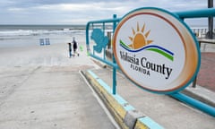 a sign reads "Volusia County Florida" on a beach