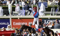 Frankie Dettori celebrates with a flying dismount at Meydan.