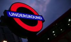 London Underground roundel sign against a night sky.