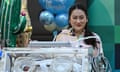 Pheu Thai Party candidate Paetongtarn Shinawatra, presents her newborn son Thasin in an incubator