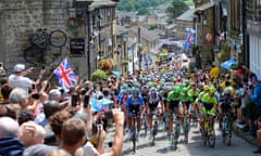 06-07-2014 of The peloton rides up Main Street as stage two of the Tour de France passes through Haworth, Yorkshire. PA Photo. Issue date: Thursday December 19, 2019. Here is the PA news agency's selection of the pictures of the decade. See PA story SPORT Decade Pictures. Photo credit should read Martin Rickett/PA Wire.