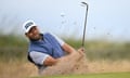 Dan Brown plays from a green-side bunker on the first hole during his second round, on day two of the 152nd British Open at Royal Troon