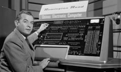 Reporter Charles Collingwood sits in front of the Remington Rand Univac Electronic Computer. It appears to be a very large switchboard.