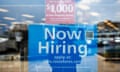A 'now hiring' sign on the window of a Ross clothing store in Rockville, Maryland.