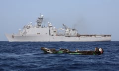 The burned-out hull of a suspected pirate skiff drifts near the USS Ashland after the gun battle in which Mohamed Hassan Farah.